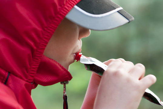 boy eating fruit puree from a tube