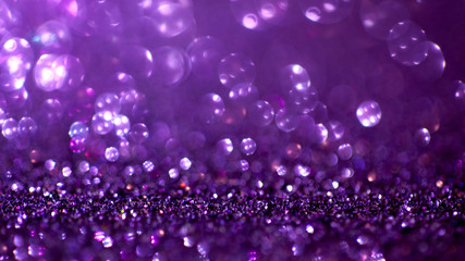 Purple glitter magic background. Defocused light and free focused place for your design.