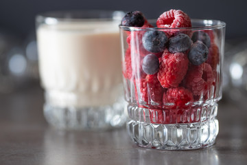 Frozen raspberries in glass and yogurt