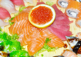 close up of sashimi sushi set with chopsticks and soy