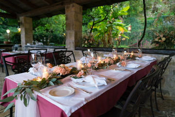 table decorated with fresh flowers and candles for a wedding dinner