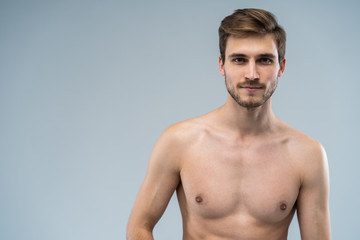 Fototapeta premium portrait of attractive confident concentrated focused seductive guy with ideal face features bearded with stylish trendy hairdress isolated on gray.