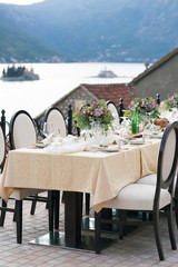 table decorated with fresh flowers for an outdoor wedding dinner