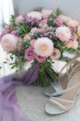 pink and lilac wedding bouquet stands on a chair