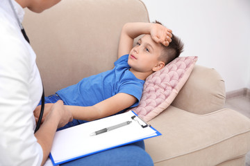 Children's doctor working with patient at home