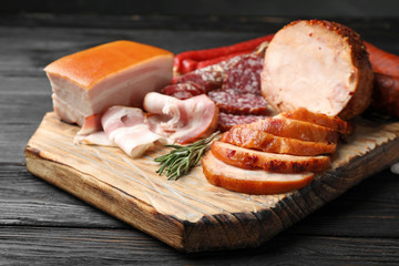 Cutting board with different sliced meat products served on table