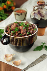 Cooked legumes meat in a bowl on an old wooden table. National dish Asia, Europe, America