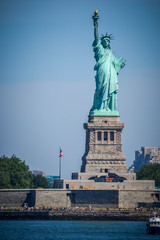 Statue of Liberty on a sunny summer day as seen from the New York Bay, portrait orientation