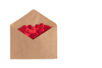 Red small hearts in a craft envelope on a white isolation background. St. Valentine’s Day card