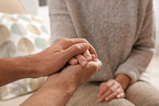 Man comforting woman, closeup of hands. Help and support concept