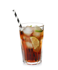 Glass of cocktail with cola, ice and cut lime on white background