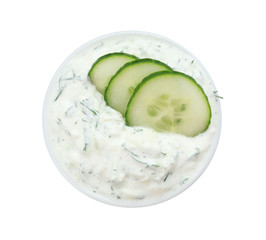 Bowl with cucumber sauce on white background, top view