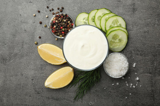 Flat lay composition with cucumber sauce and ingredients on grey background