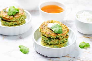 Zucchini ricotta cilantro fritters with fresh cilantro leaves