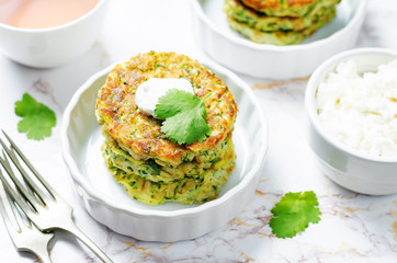 Zucchini ricotta cilantro fritters with fresh cilantro leaves