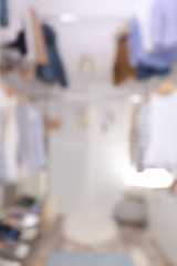 Obraz na płótnie Canvas Blurred view of modern dressing room with stylish clothes