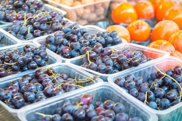 Red grapes and various fruits in the market