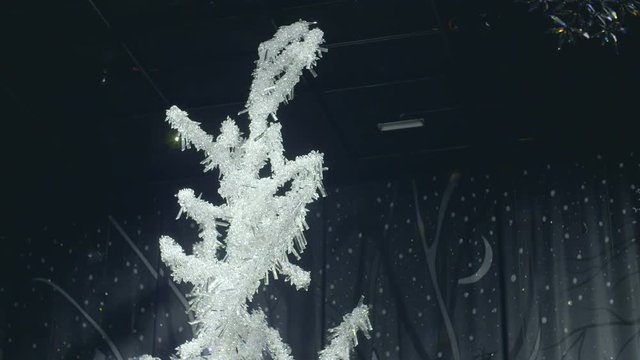 Frozen winter background with artificial ice crystals. trees made of frosted glass