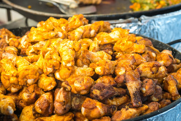 traditional roasted chicken and potatoes near the entrance to the butcher shop in the city center of Paris