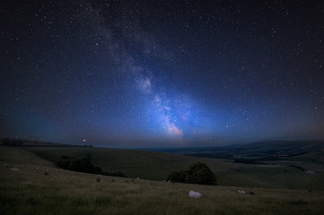 Obraz na płótnie Canvas Vibrant Milky Way composite image over landscape of Steyning Bowl on South Downs