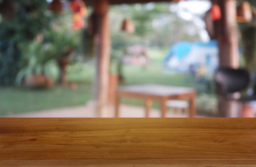 Empty wooden table in front of abstract blurred green of garden and house background. For montage product display or design key visual layout - Image..