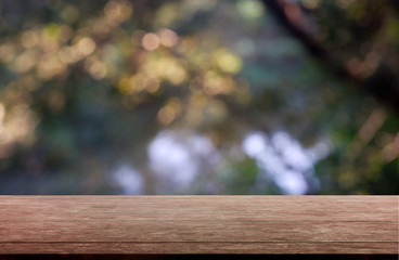 Empty wooden table in front of abstract blurred green of garden and trees .background. For montage product display or design key visual layout - Image.