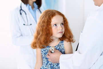 Doctor examining a little girl with stethoscope.Medicine and healthcare concept