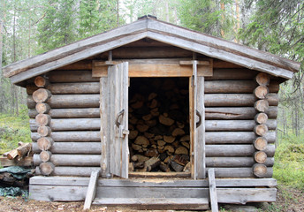 Fototapeta na wymiar Arctic Circle Hiking Area. A wooden cabin for keeping firewood