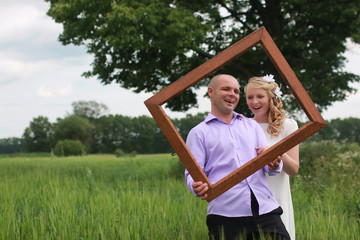Obraz premium Couple lovers walking in field in summer day