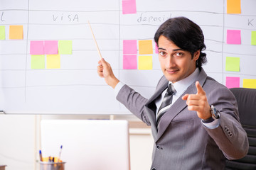 Young handsome employee working in the office