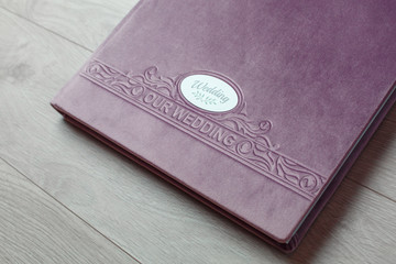 pink photo book with  fabric cover..
Photo book on a light background.

Photo album with a hard cover on a wooden background.
Bright  photo album.

