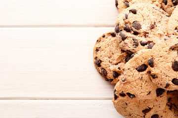 Delicious chocolate chip cookies on a white wooden background. Place for text. Top view.