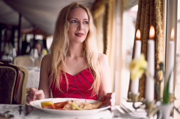 beautiful fashion woman in red dress in restaurant