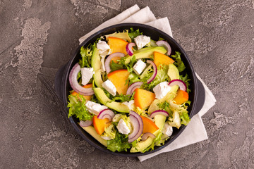 Delicious salad with frisee, persimmon, feta, chicken fillet and onion