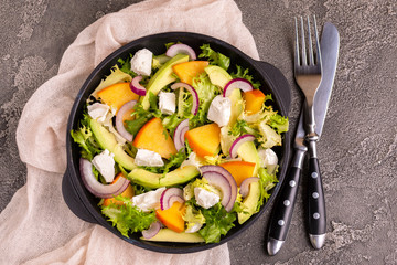 Delicious salad with frisee, persimmon, feta, chicken fillet and onion