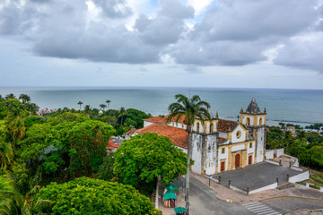 The architecture of the historic city of Olinda in Pernambuco, Brazil showcasing the Se Church dated from the 17th century in Baroque style at sunset.