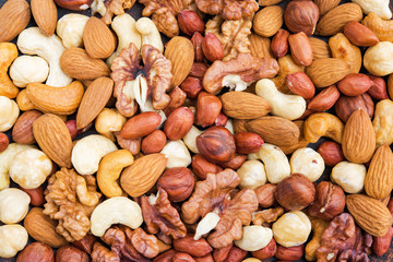 Top view of tasty mix nuts background. Concept healthy snack.