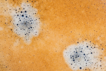 Black coffee crema foam texture.
