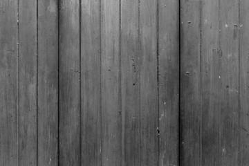 Obraz premium Full frame background of an old, faded and dirty wood board wall in black and white.