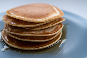 Sweet homemade stack of pancakes with maple syrup for breakfast
