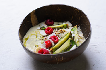 Smoothie Bowl Topped with Raspberry, Kiwi, Chia, Flaxseed and Coconut