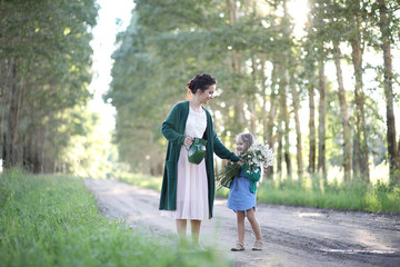 Mother with daughter walking on a road