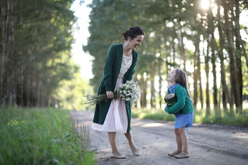 Mother with daughter walking on a road