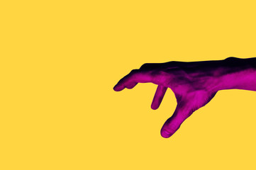 Isolated hand photo on yellow background. Pink hand collage style. Bright pop art template with space for text. Creative minimalistic backdrop. Poster, banner idea. Gestures with fingers
