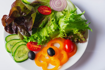 Fresh mixed vegetables salad with black olives, cherry tomatoes and sweet bell pepper . Close up . Selective focus. Vegetarian menu.
