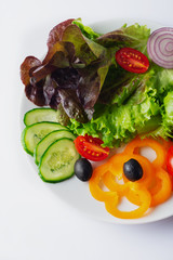 Fresh mixed vegetables salad with black olives, cherry tomatoes and sweet bell pepper . Close up . Selective focus. Vegetarian menu.