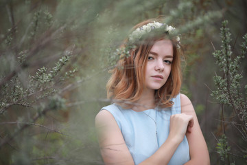 Girl in blue dress in green park