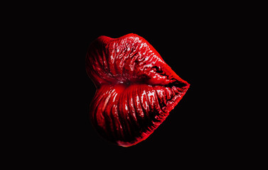 Juicy lips isolated on a black background. Perfect red lips isolated on white background. Beautiful lipstick. Makeup. A sensual mouth. Woman for advertising, the model depicts the emotion of a kiss