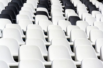 Fototapeta premium Empty black and white stadium seats mixed in rows, diversity concept