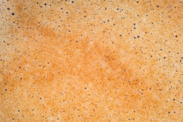 Black coffee crema foam texture.